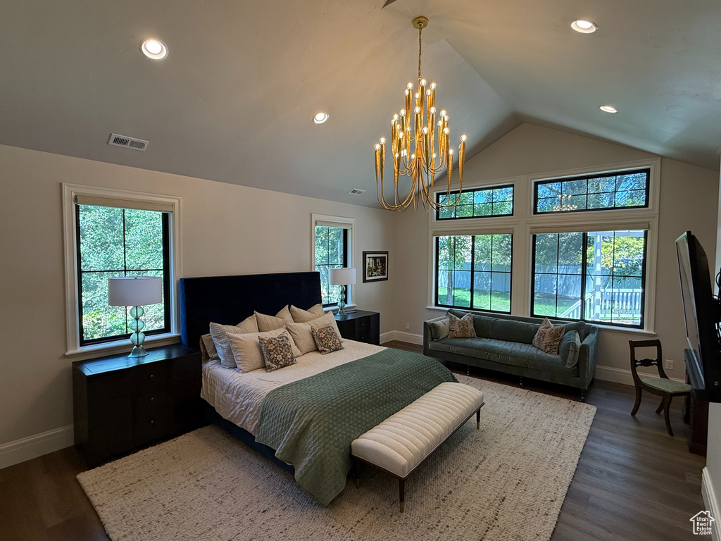 Bedroom featuring lofted ceiling, a chandelier, dark wood-style flooring, and recessed lighting