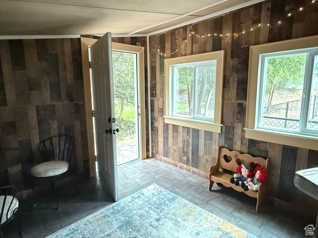 Doorway featuring wood walls