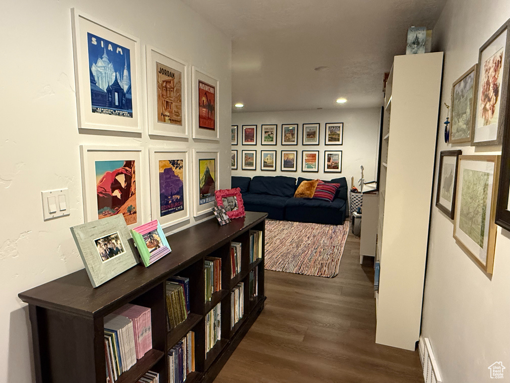 Hall featuring dark wood-style flooring and recessed lighting