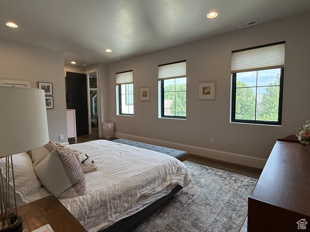 Bedroom featuring wood finished floors, recessed lighting, and a walk in closet
