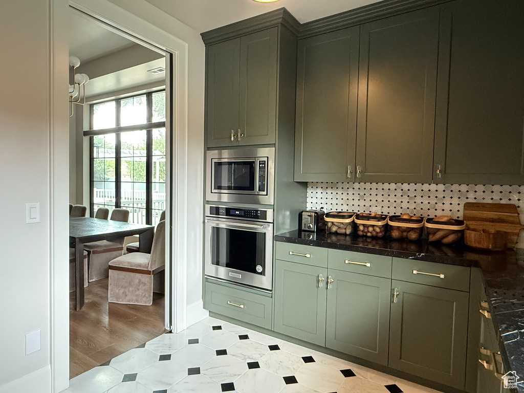 Kitchen with appliances with stainless steel finishes and light flooring