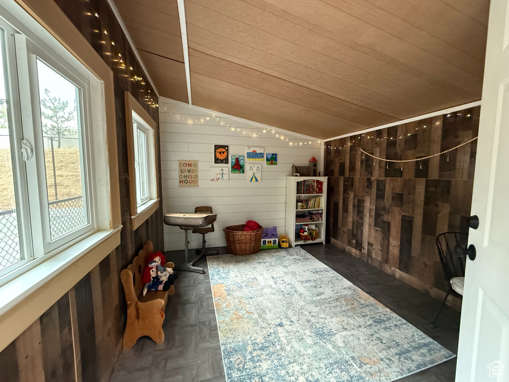 Sunroom featuring vaulted ceiling