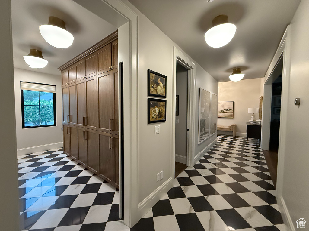 Hallway with light flooring and baseboards