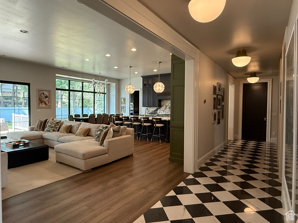 Living area featuring recessed lighting, a chandelier, and wood finished floors