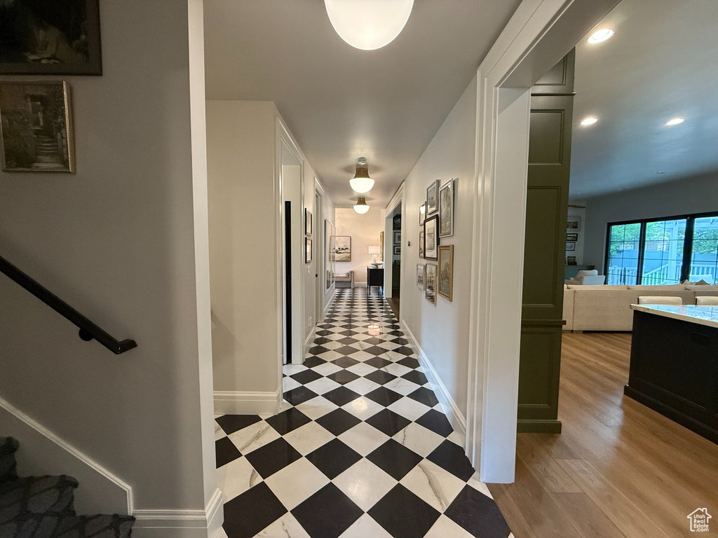 Hallway with recessed lighting and stairs