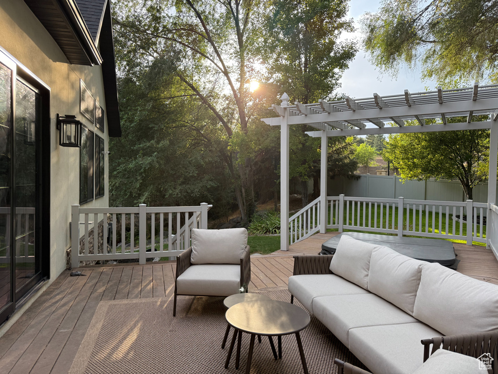 Deck with an outdoor hangout area and a pergola