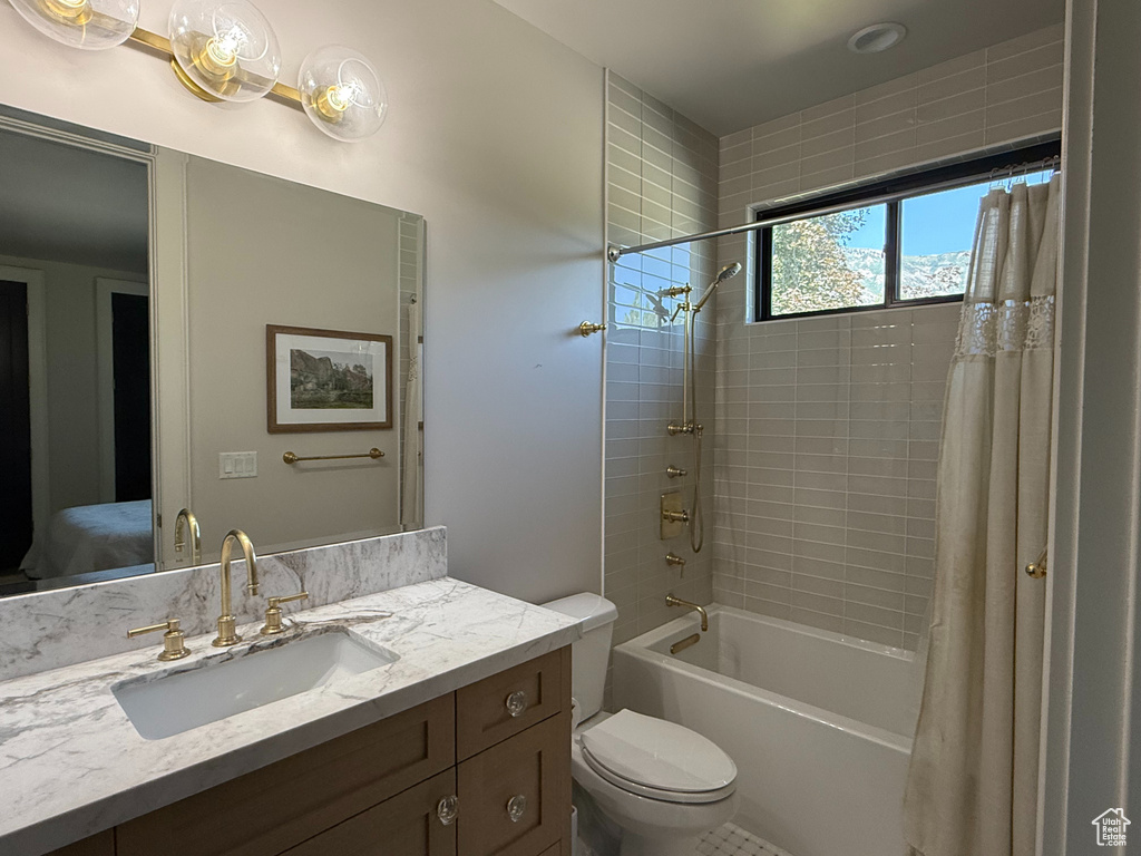Bathroom featuring vanity and shower / tub combo with curtain