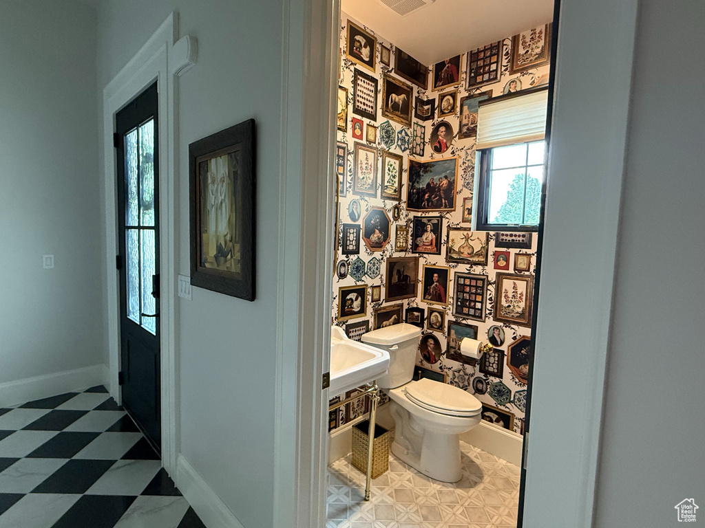 Bathroom featuring toilet and tile patterned floors