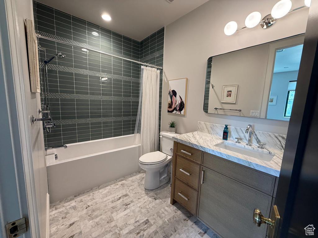 Full bathroom featuring vanity and shower / bathtub combination with curtain