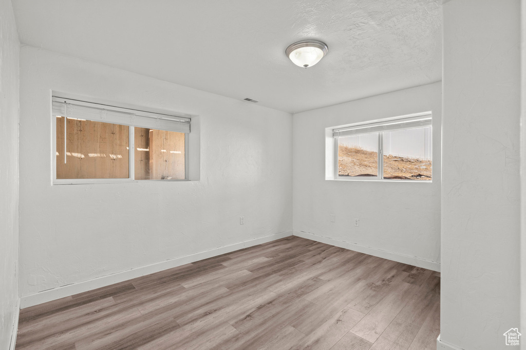 Spare room with wood finished floors and baseboards