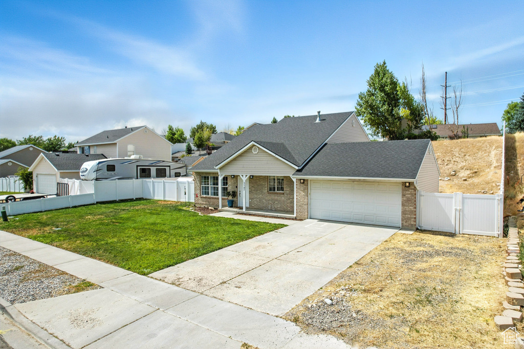 Traditional home with concrete driveway, a garage, brick siding, covered porch, and roof with shingles