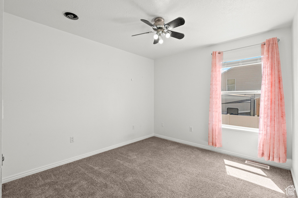 Unfurnished room with carpet flooring and a ceiling fan