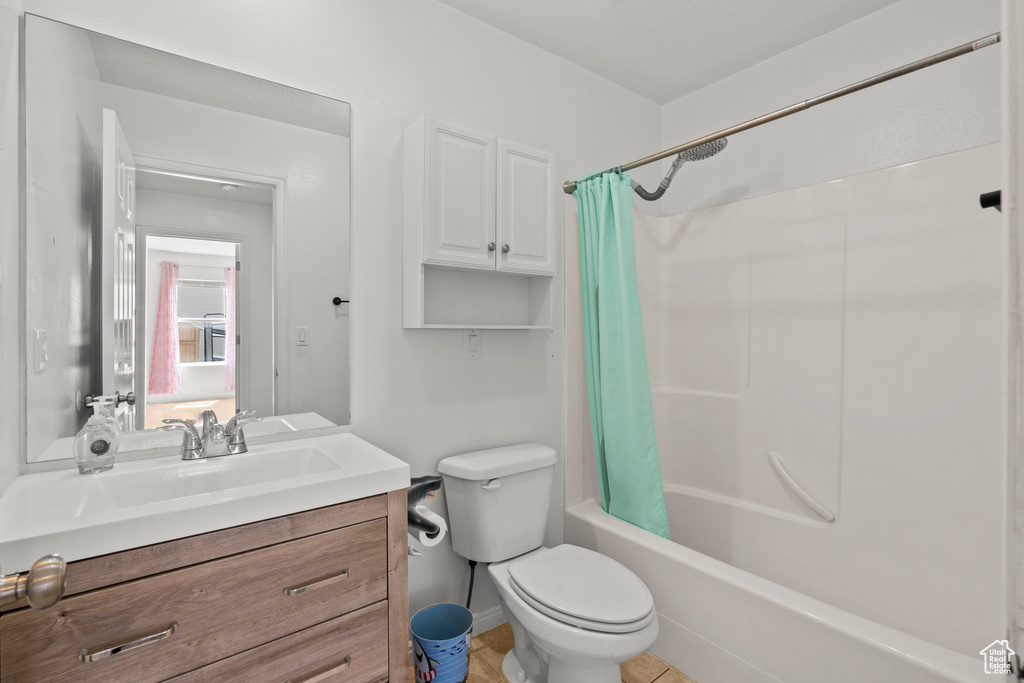 Full bathroom featuring shower / bath combo with shower curtain and vanity