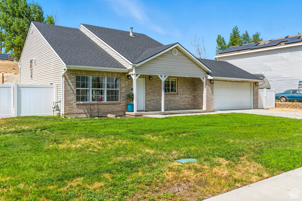 View of front of property featuring a porch, a garage, driveway, and a shingled roof