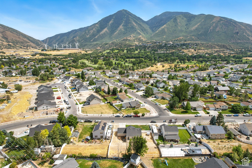 Aerial overview of property's location featuring a mountain backdrop and nearby suburban area