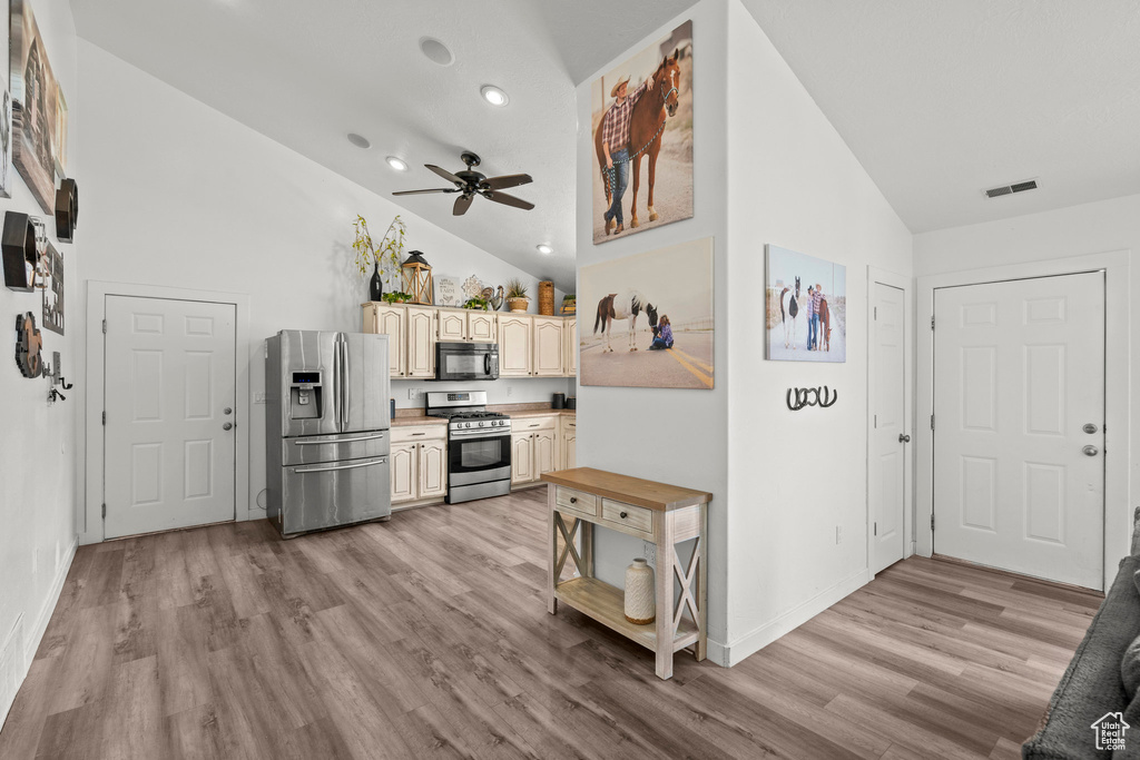 Kitchen featuring stainless steel appliances, light wood finished floors, a ceiling fan, recessed lighting, and light countertops
