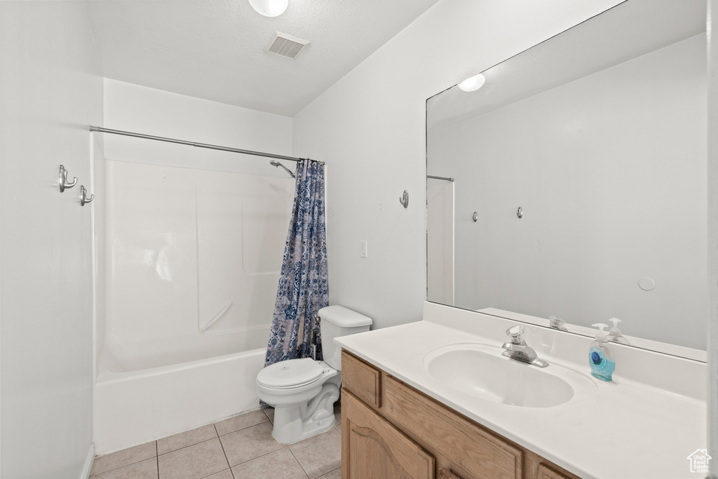 Full bathroom featuring vanity, tile patterned floors, and shower / bath combo