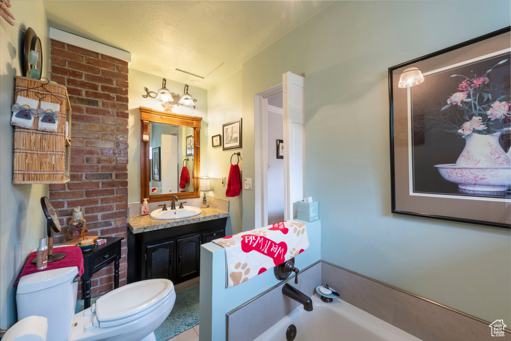 Full bath featuring a garden tub and vanity