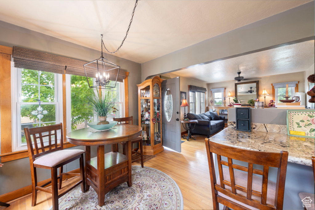 Dining area featuring light wood-type flooring and a chandelier