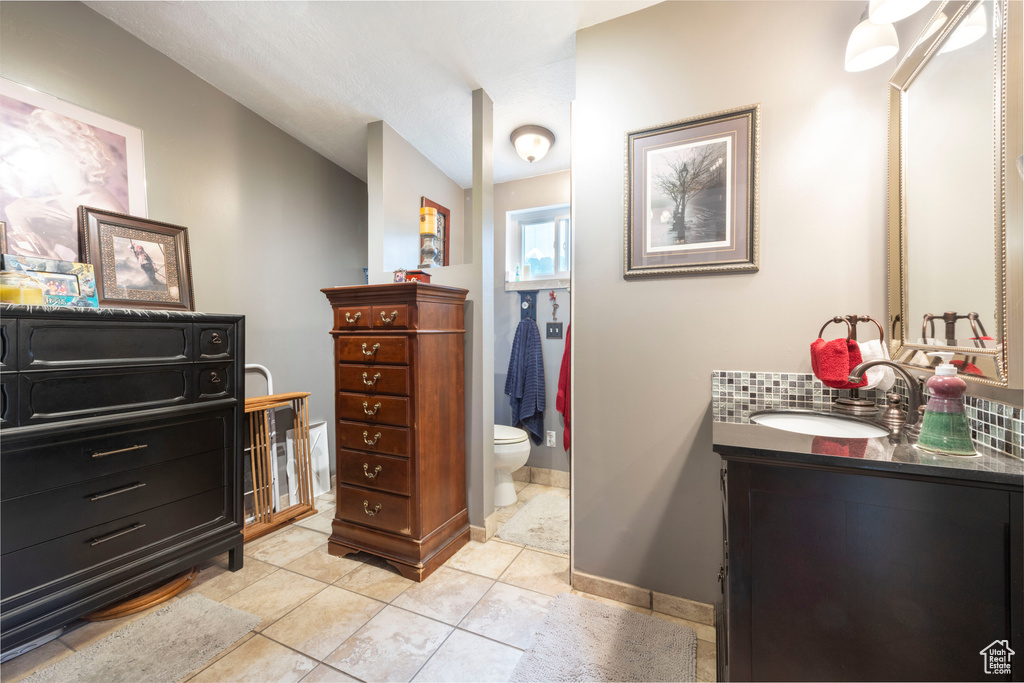 Full bath featuring vanity and tile patterned flooring
