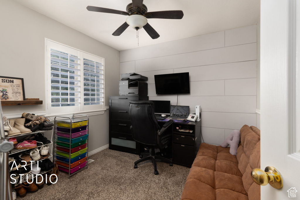 Carpeted office with a ceiling fan