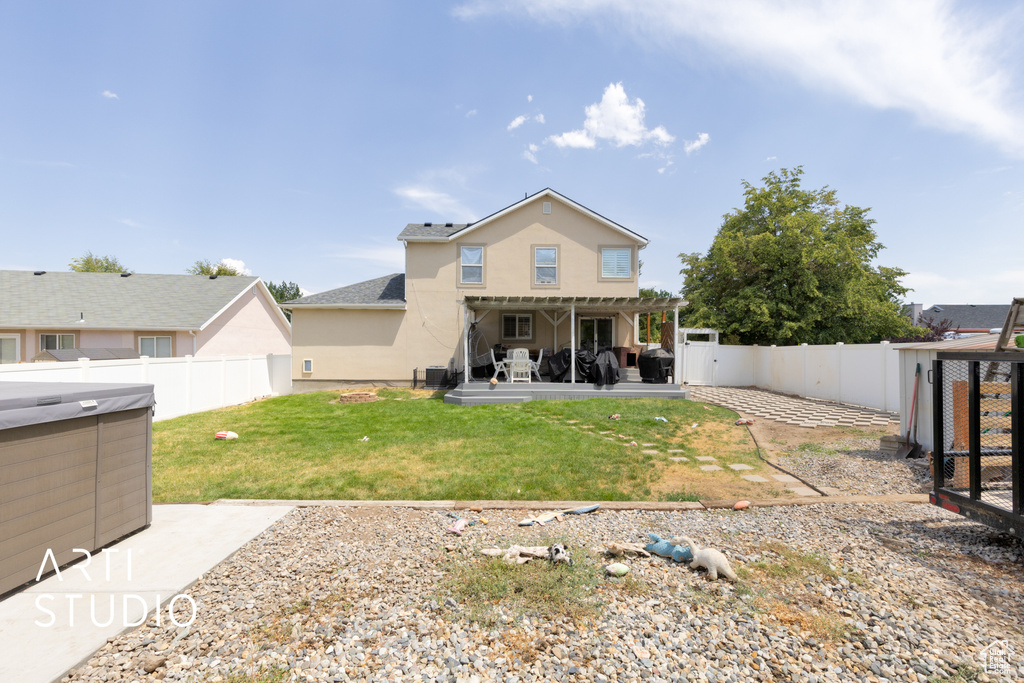 Rear view of house featuring a patio area, a fenced backyard, and stucco siding