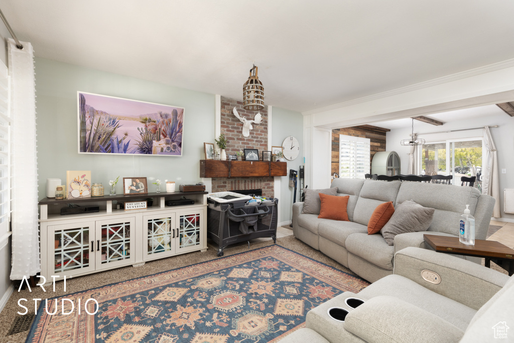 Carpeted living room featuring a fireplace and baseboards
