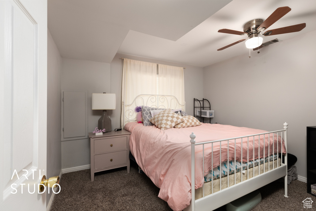 Carpeted bedroom featuring baseboards and ceiling fan