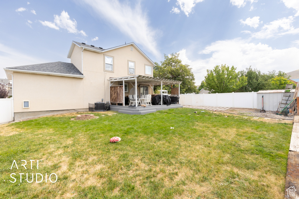 Back of house featuring a pergola, stucco siding, a fenced backyard, and a patio