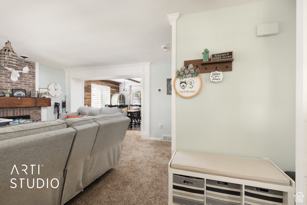Carpeted living area with a fireplace