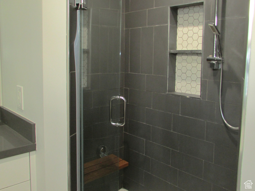 Bathroom with a stall shower and vanity