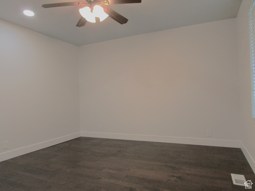 Unfurnished room featuring ceiling fan, recessed lighting, and dark wood-style flooring