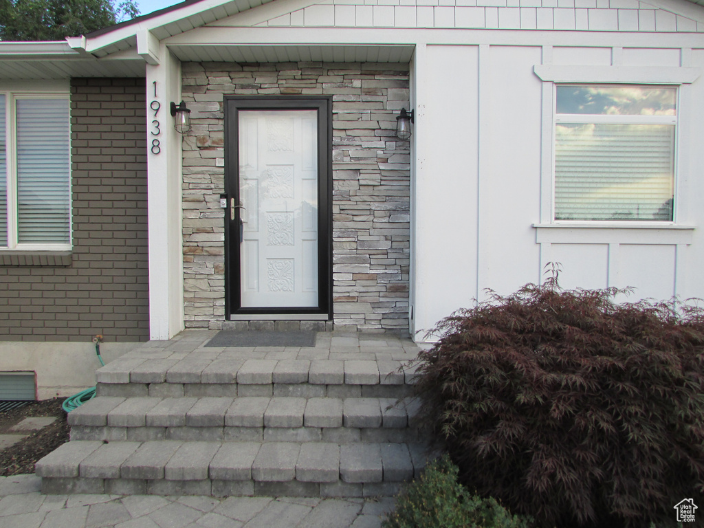 Property entrance featuring stone siding