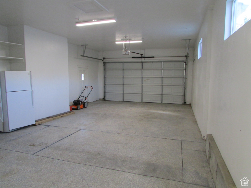Garage featuring freestanding refrigerator