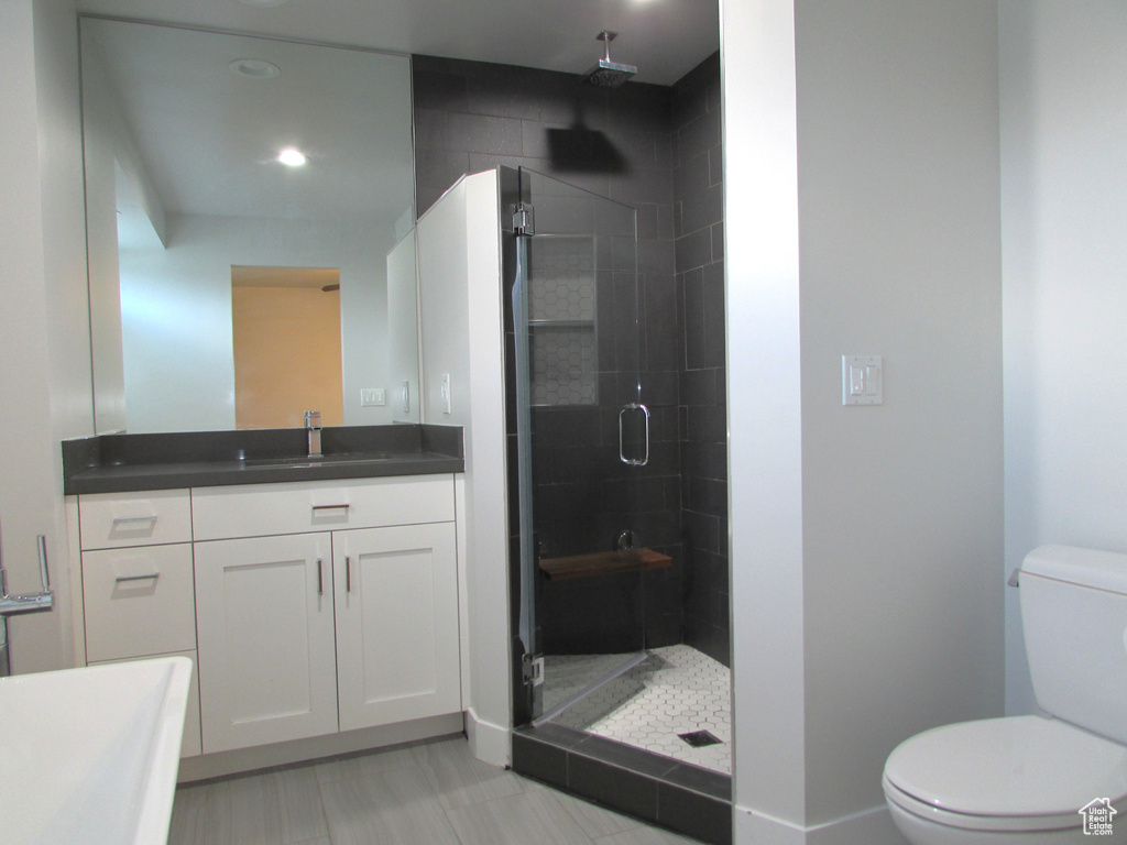 Full bathroom featuring a shower stall, vanity, and recessed lighting