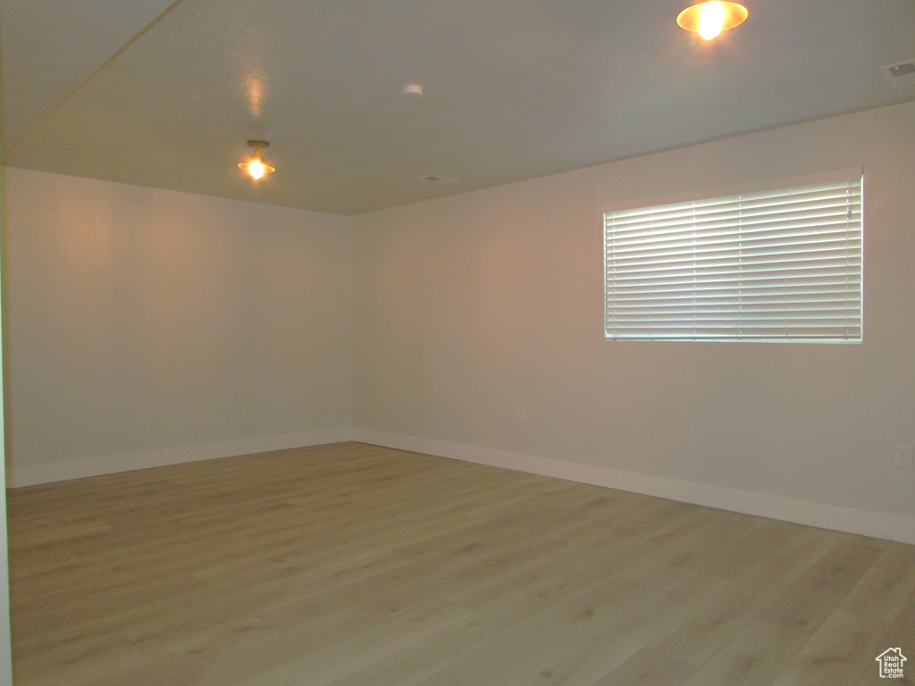 Unfurnished room featuring light wood-type flooring and baseboards