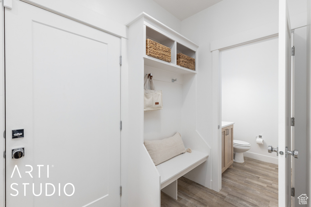 Mudroom featuring light wood-style floors and baseboards
