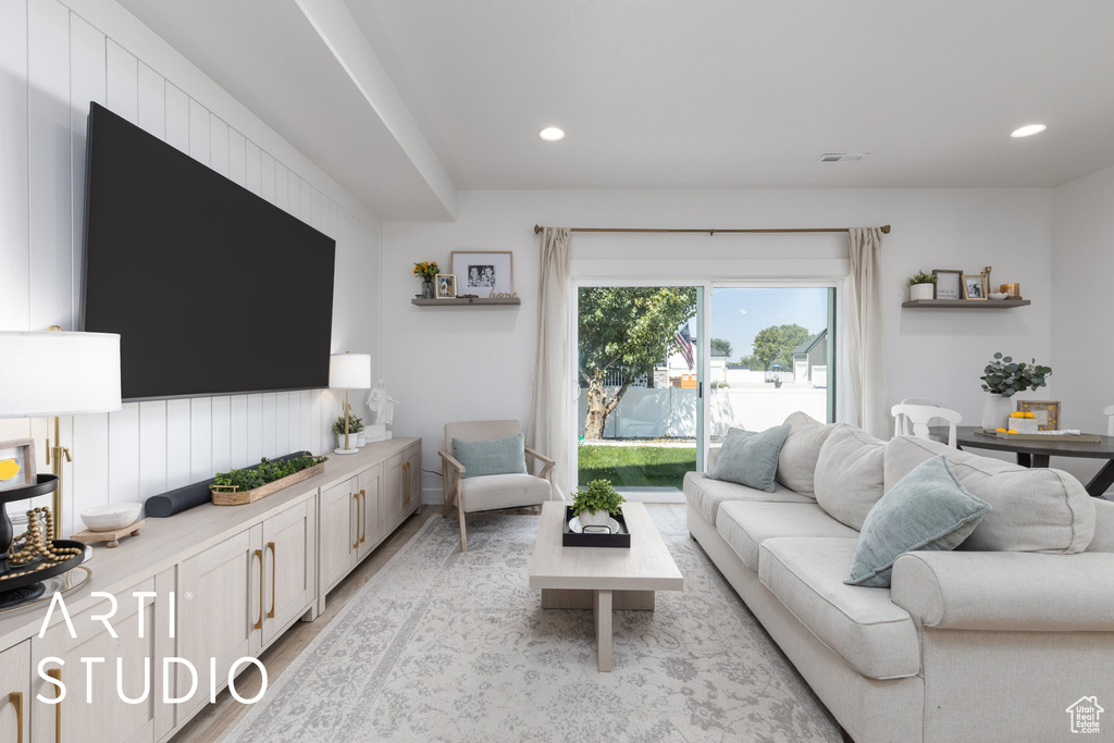 Living room featuring light wood finished floors and recessed lighting