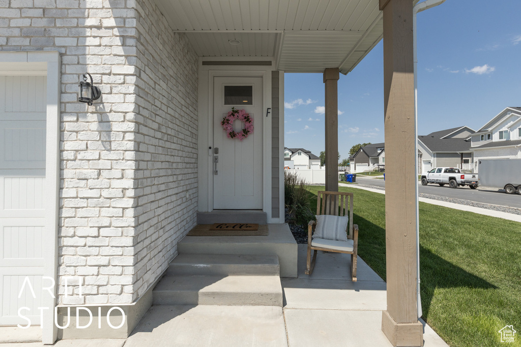 Property entrance featuring a residential view and a lawn