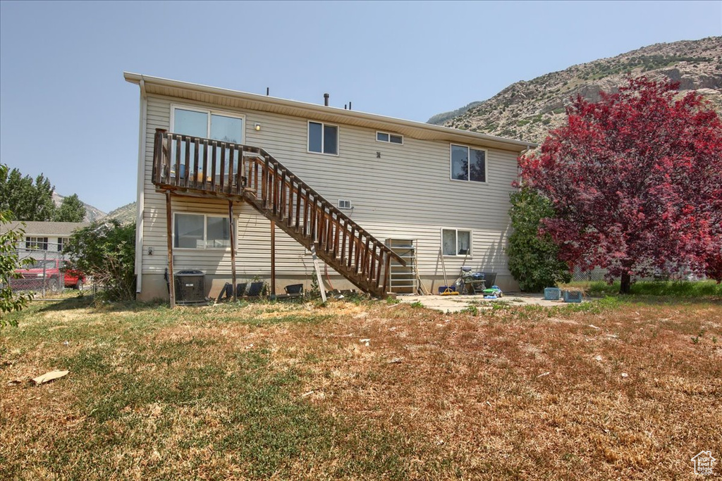 Back of house featuring a mountain view and stairs