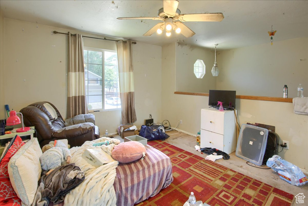 Living area with healthy amount of natural light and a ceiling fan