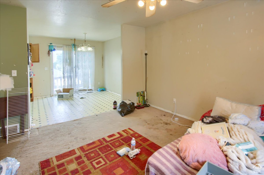 Carpeted living room featuring ceiling fan