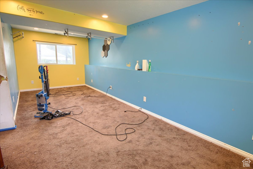 Exercise room with carpet floors and recessed lighting