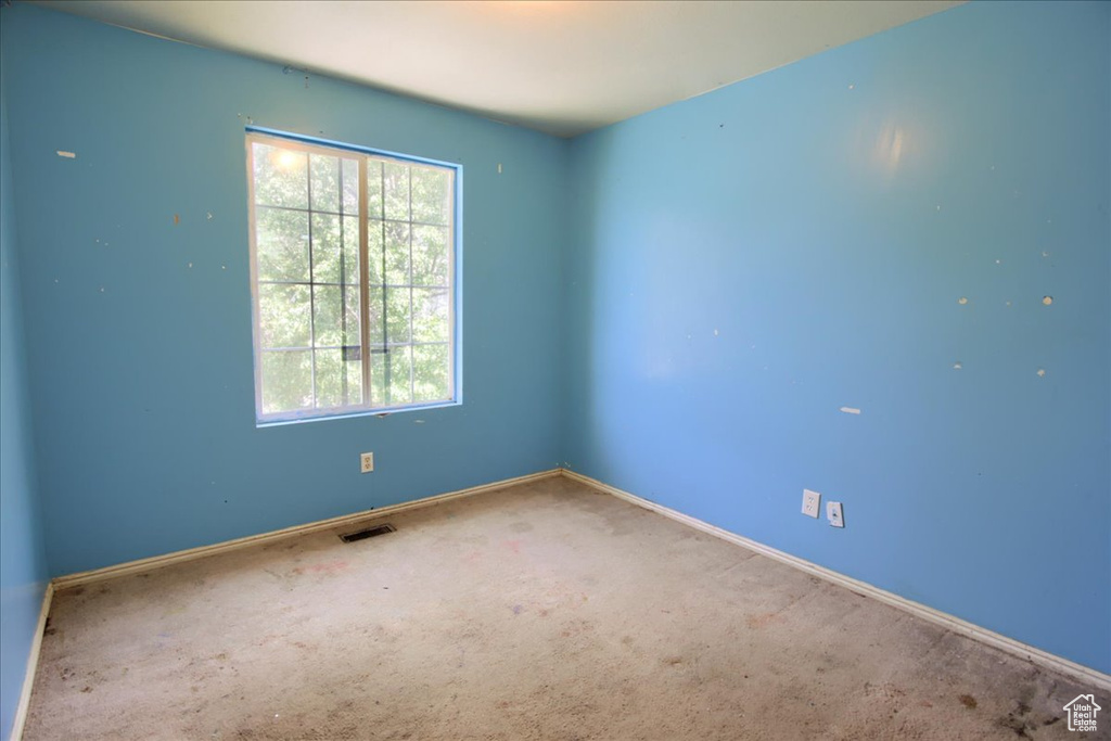 Unfurnished room featuring carpet and baseboards