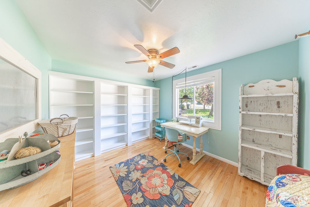 Home office featuring wood finished floors and ceiling fan