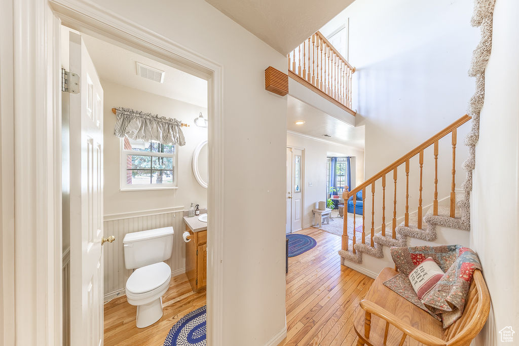 Half bath featuring hardwood / wood-style floors and vanity