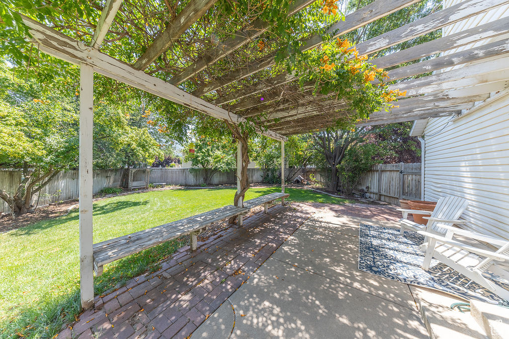 Fenced backyard featuring a pergola and a patio area