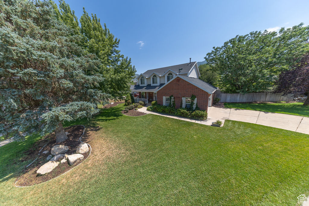 Traditional home with brick siding and concrete driveway