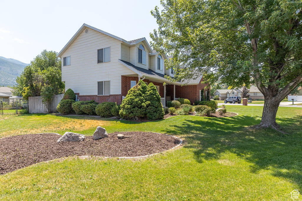 View of side of property with brick siding and a mountain view