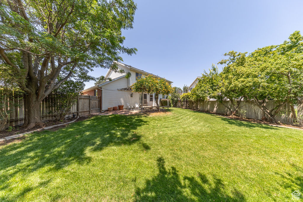 Fenced backyard featuring a patio